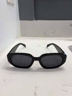 Black women’s Prada sunglasses